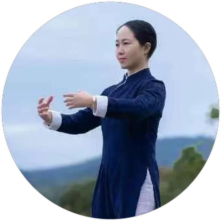 Lidan in a taiji posture with hills behind her