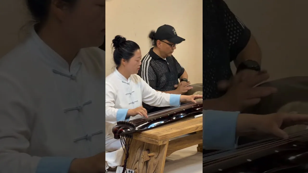 Two participants play guqin and handpan during the Wudang Mountain musical exchange.