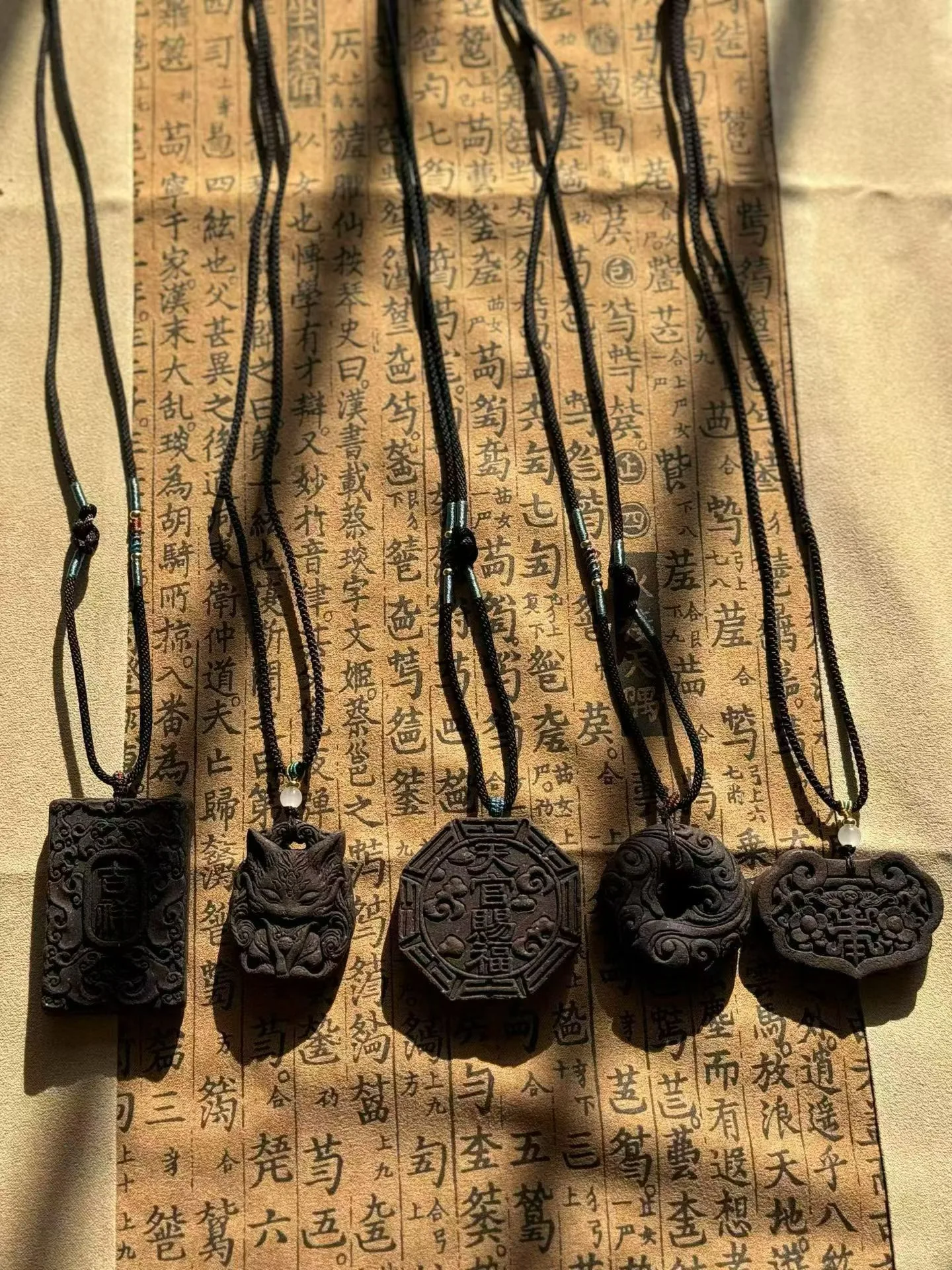 Des pendentifs d’encens façonnés à la main sont suspendus à des cordons tressés.
